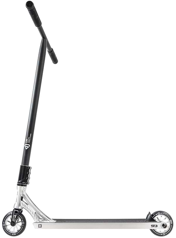 The CORE ST3 Complete Stunt Scooter - Polished by CORE features a silver and black design, T-shaped handlebar with black grips, small black and white wheels, and a sleek pro-grade aluminum deck, shown side-on against a white background.