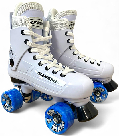 A pair of Supreme Turbo 33 Nylon Quad Roller Skates in white with blue swirl wheels and white laces, featuring "SUPREME" branding on the side, shown against a plain white background.