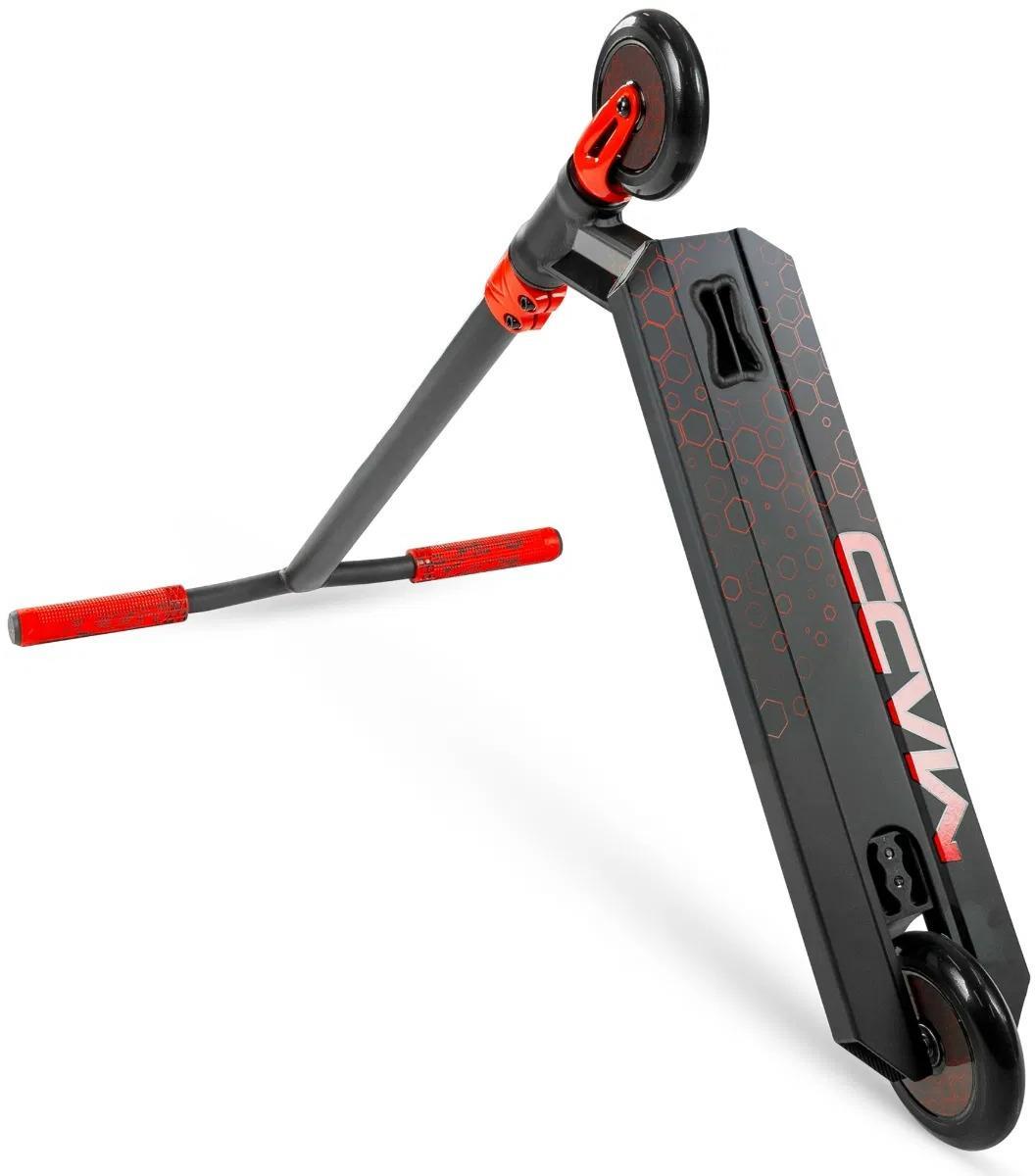 The Madd Gear Viral Rave Complete Stunt Scooter - Inferno features a black and red design, hexagonal deck pattern, "CCVM" lettering, red grips, and small wheels—ideal for kids learning tricks.