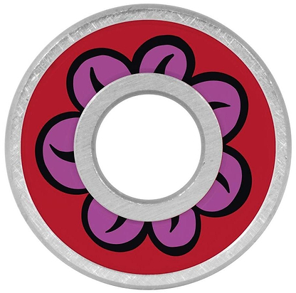 The round metal object has a red center with a five-petaled purple flower outlined in black, each petal containing a black curve. The hollow circle resembles Bronson Speed Co. Fabiana Delfino Pro G3 skateboard bearings.