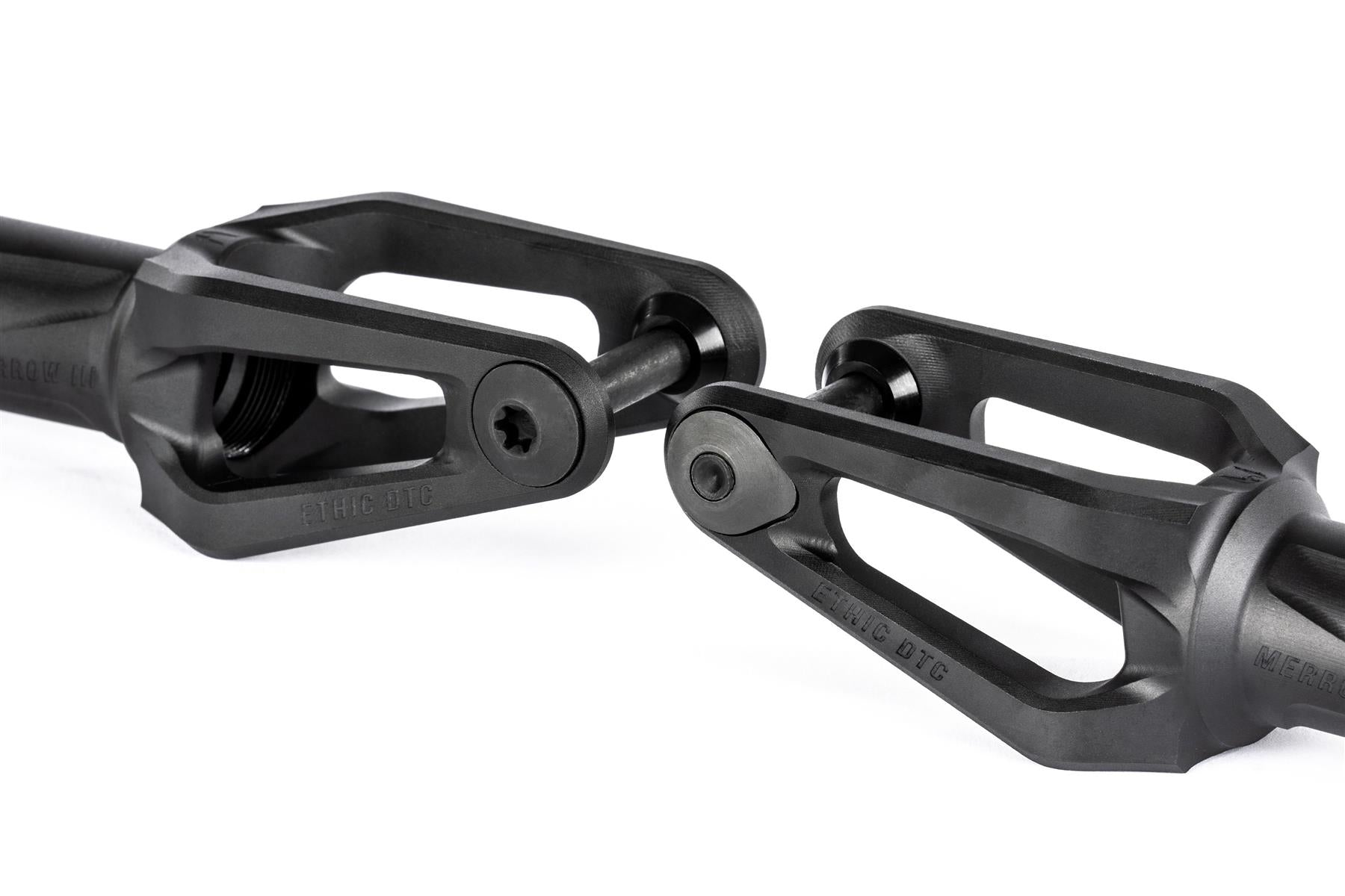 Close-up of two Ethic DTC Merrow V3 8/12STD HIC Stunt Scooter Forks in black, aligned facing each other with bolts, against a white background.