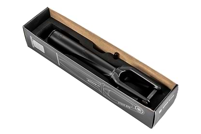 The Ethic DTC Merrow V3 SCS Stunt Scooter Fork in black, crafted from 7075 aluminium and among the lightest forks, is seen from above in a partially open cardboard box with black and white printed graphics.