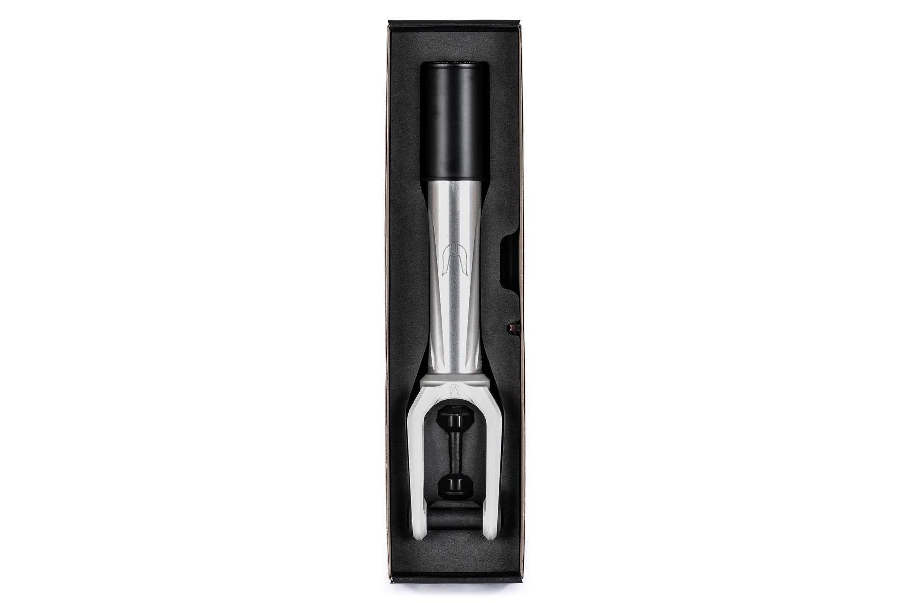 A raw Ethic DTC Merrow V3 8/12STD HIC stunt scooter fork is securely packaged in a black rectangular box with foam padding, viewed from above.