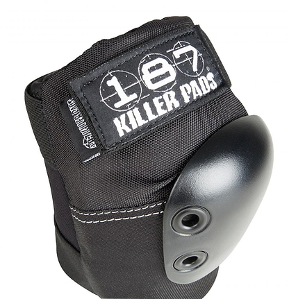 Close-up of a black elbow pad with a hard shell and two rivets, embodying high-performance design. The pad is labeled "187" on the fabric above the shell, ensuring superior comfort for demanding activities.