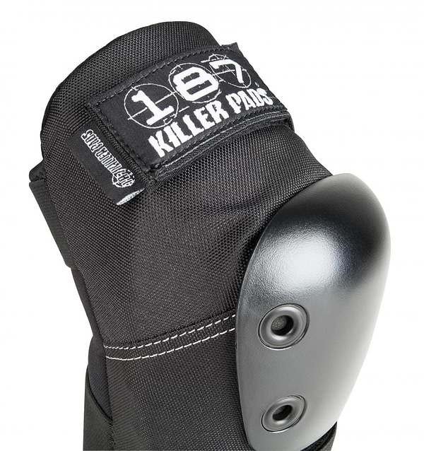 Close-up of a black elbow pad featuring a hard shell, two rivets, and a fabric label reading "187 Killer Pads." The white stitching and rugged design indicate it's for impact protection. Perfect for anyone in need of reliable gear like the 187 Killer Pro Elbow Skate Protection Pads - Black.