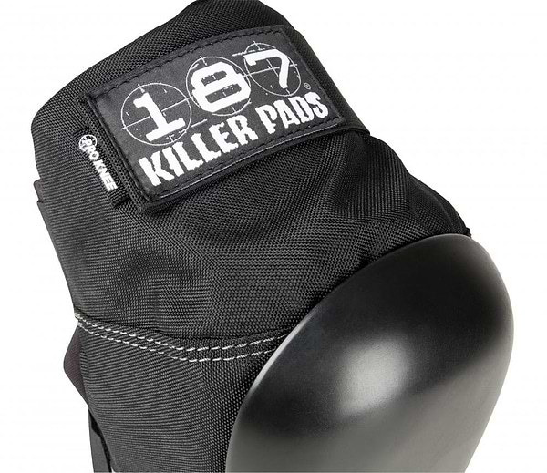 Close-up of a black knee pad from the 187 Killer Pro Knee Skate Protection Pads collection, showcasing a "187" logo on its fabric tag. Designed to cater to action sports enthusiasts, it boasts durable stitching and a smooth, rounded cap for dependable protection against significant impacts.
