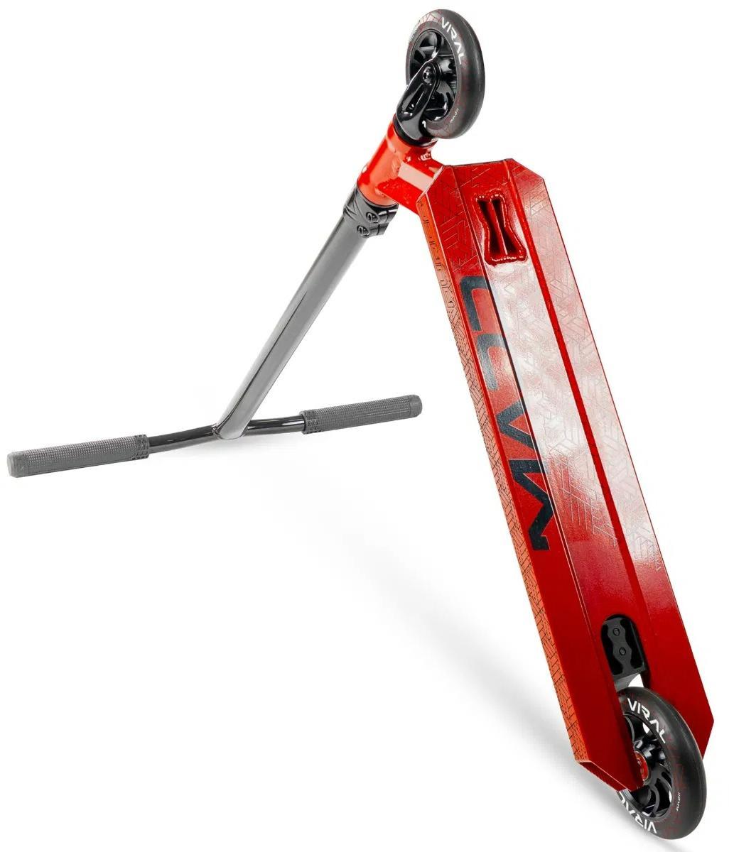 The Madd Gear Viral Purge Complete Stunt Scooter - Cherry stands upright on its rear wheel, displaying its vibrant deck and handlebars—perfect for action at the skatepark, all set against a white background.