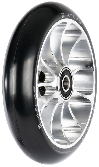 A close-up of the Ethic DTC Atlas 110mm Stunt Scooter Wheel - Raw shows its shiny black and silver finish, intricate metal spokes, lightweight design, built-in bearing, and “ATLAS” branding.