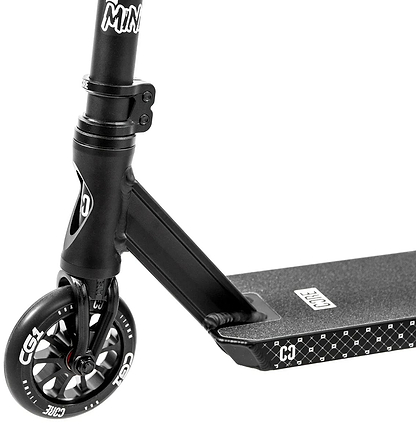 Close-up of the CORE CG1 Mini Complete Stunt Scooter in black, highlighting the handlebar stem, front wheel, and part of the deck with a geometric pattern and visible CORE branding.