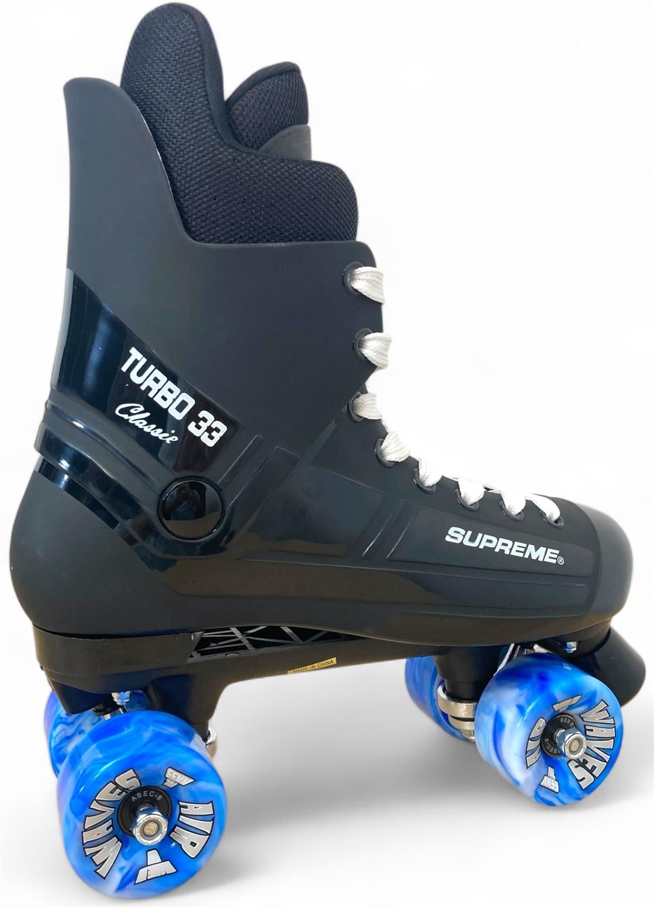 A black Supreme Turbo 33 Nylon Quad Roller Skate with white laces and blue swirl wheels, shown from a side angle on a white background.