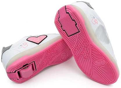 Breezy Rollers Blast Shoes - Pink by Breezy Rollers are white sneakers with pink and gray accents, heart designs, pink soles, and retractable heel wheels—perfect for skating or walking in style.