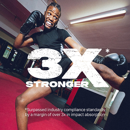 A smiling man in boxing gloves and athletic gear throws a high kick in a gym, confidently wearing the Safejawz Intro Series Protection Mouthguard - White. Large text reads "3X STRONGER." Smaller text highlights impact absorption and jaw stability beyond industry standards.