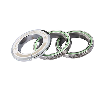 The Blunt Envy Low Stack SCS Integrated Stunt Scooter Headset in Chrome features a set of three bearings with a minimalist design and engraved text. Each round piece showcases a smooth finish paired with green inner rings. The top component includes unique cutout notches, and all pieces come equipped with fully sealed bearings to ensure enhanced durability.