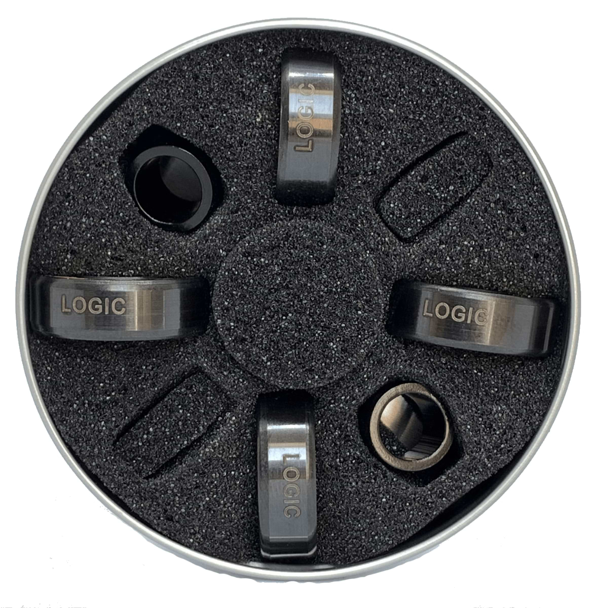 A round metal container comes with a black foam insert and houses four cylindrical metal objects, each featuring the "LOGIC" label. These premium quality Scooter Bearings are laid out in an evenly spaced circular arrangement, delivering top performance speed and crafted to ABEC 11 standards under the Logic brand.