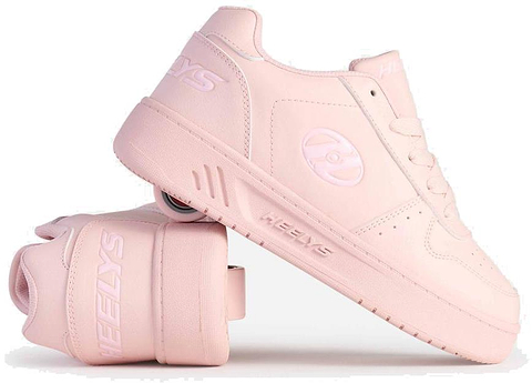 A pair of Heelys Kama Girls Shoes - Pink by Heelys, with one upright and the other on its side, displays court-style shoes featuring hidden low-profile wheels in the sole.