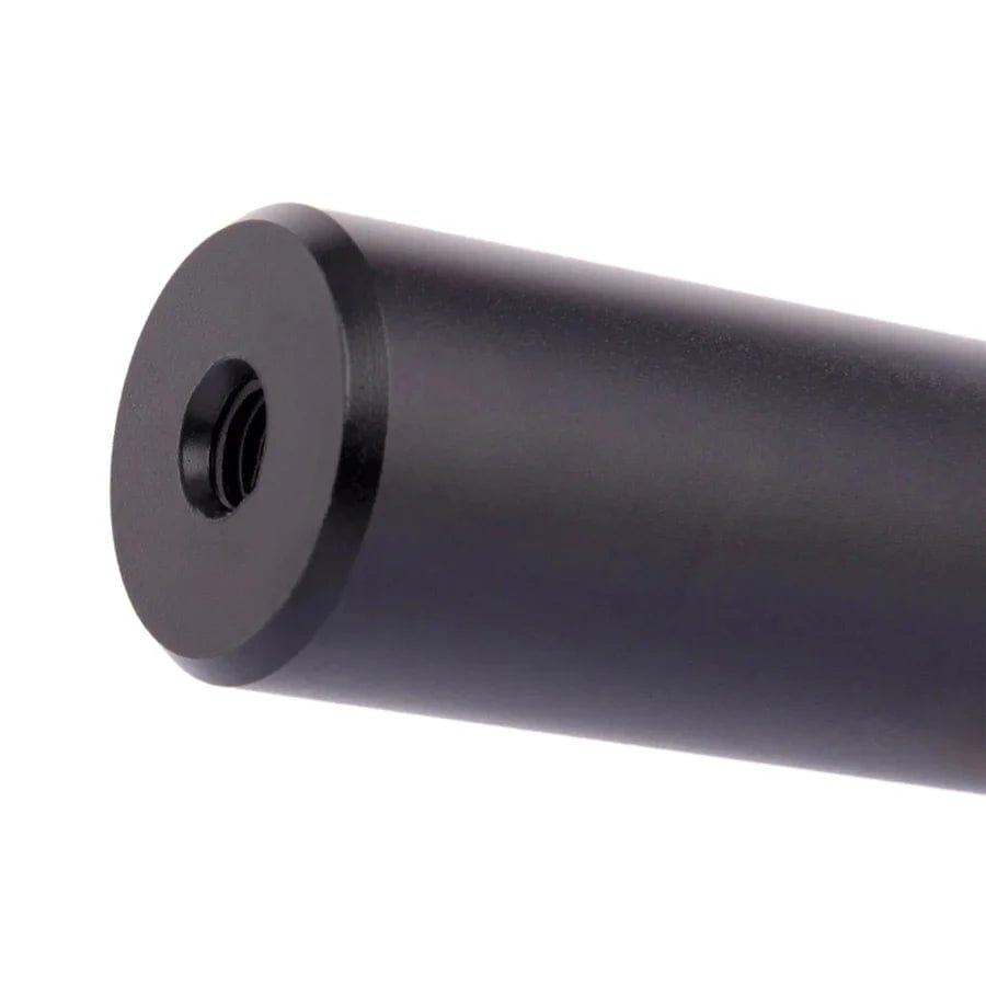A close-up reveals a sleek, cylindrical object crafted from high-grade black metal, featuring a hollow center on one end. Its smooth matte finish and subtle reflections accentuate its curves, reminiscent of the premium CORE ST2 SCS/HIC Stunt Scooter Forks by CORE.