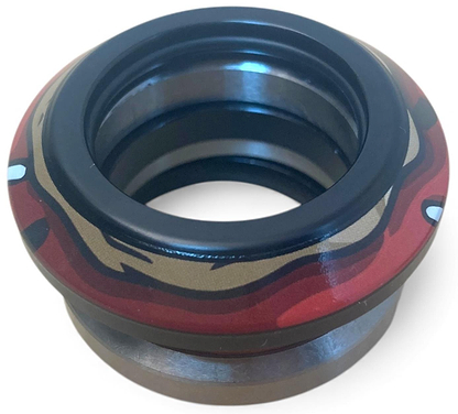A close-up of the Chubby Doughnut Integrated Stunt Scooter Headset by Chubby, featuring sealed bearings, a black inner ring, and decorative red and gold detailing—designed for stunt scooter steering assemblies.