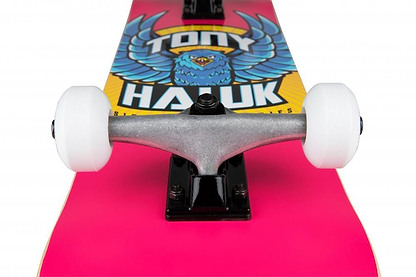 Close-up of the Tony Hawk SS 180+ Eagle Logo Pink Complete Skateboard (7.75" x 31") with white wheels and a colorful eagle graphic—an ideal complete skateboard for beginners from the Tony Hawk brand.