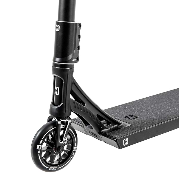Close-up of the CORE ST3 Complete Stunt Scooter in black, showing pro-grade front wheel, fork, handlebars, and a grippy deck with distinctive white "CORE" branding on the wheel and deck.