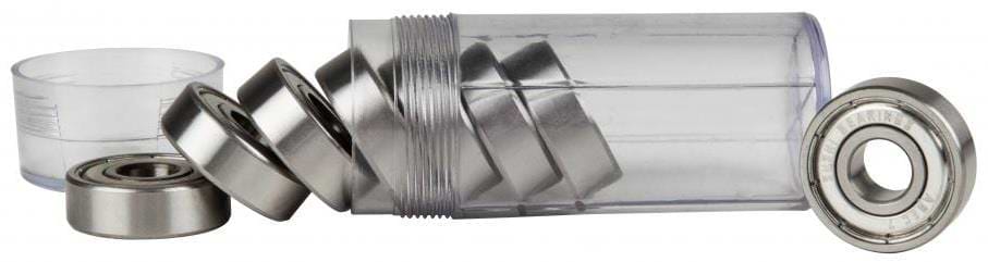 A transparent cylindrical container, open with several Sushi Chrome ABEC 7 Skateboard Bearings, spills some while others remain. Additional precision bearings are visible beside it, and the separated cap lies nearby.