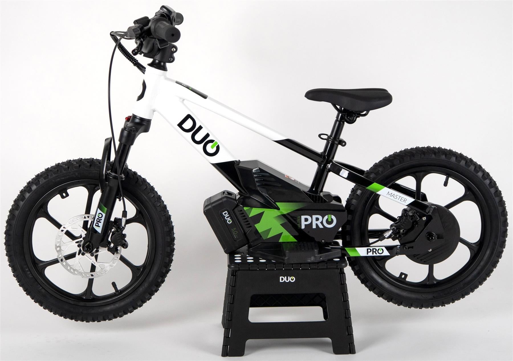 The Duo 16" Master Pro Kids Electric Balance Bike, in white and black with thick tires and disc brakes, is shown on a black stand against a plain white background.