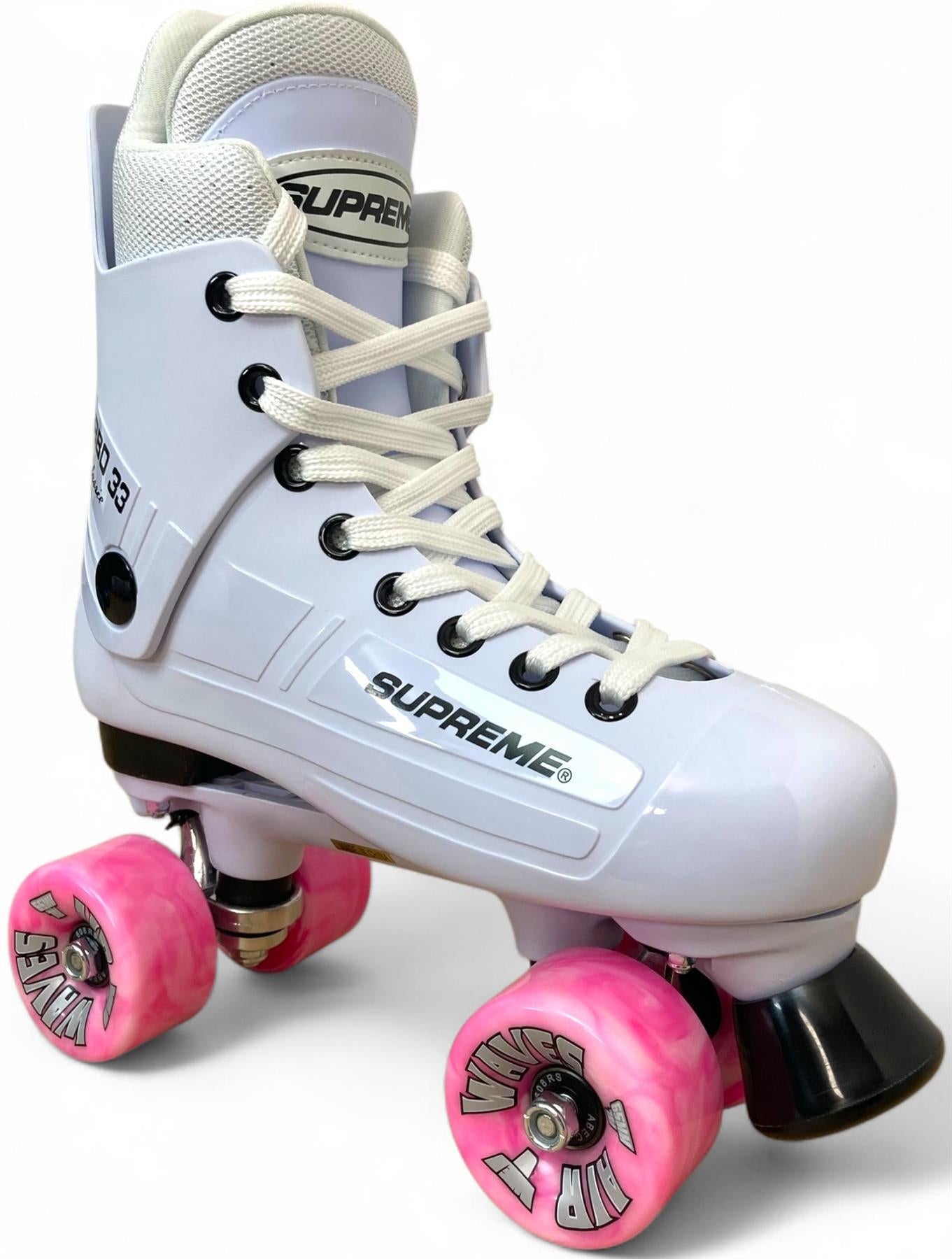 The Supreme Turbo 33 Nylon Quad Roller Skates feature a white high-top design, pink swirl wheels, black toe stop, white laces, and "SUPREME" branding on the side, shown against a white background.