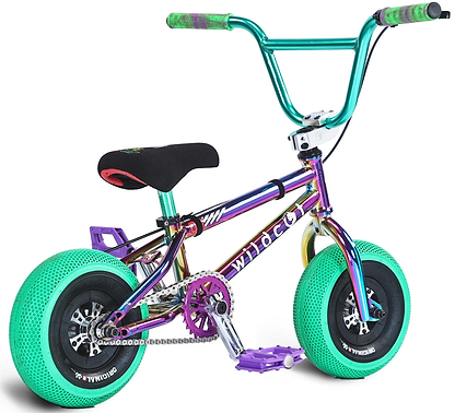 The Wildcat OG Pro Mini BMX Bike - Joker Green Hulk features a metallic rainbow frame, thick bright green turbo wheels, a black seat, teal and purple handlebars and pedals, and "wildcat" on the frame.