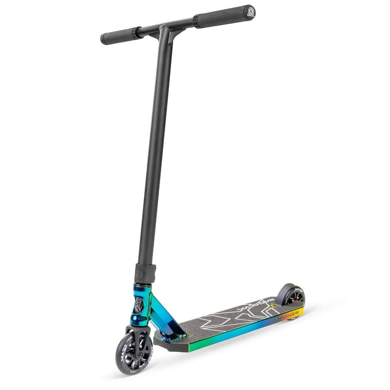 The Madd Gear MG 6 Kinetic Complete Stunt Scooter (Neochrome/Black) features black handlebars, small black wheels, a colorful neochrome aluminum deck with blue-yellow gradients, high-speed bearings, and a grip-taped surface.