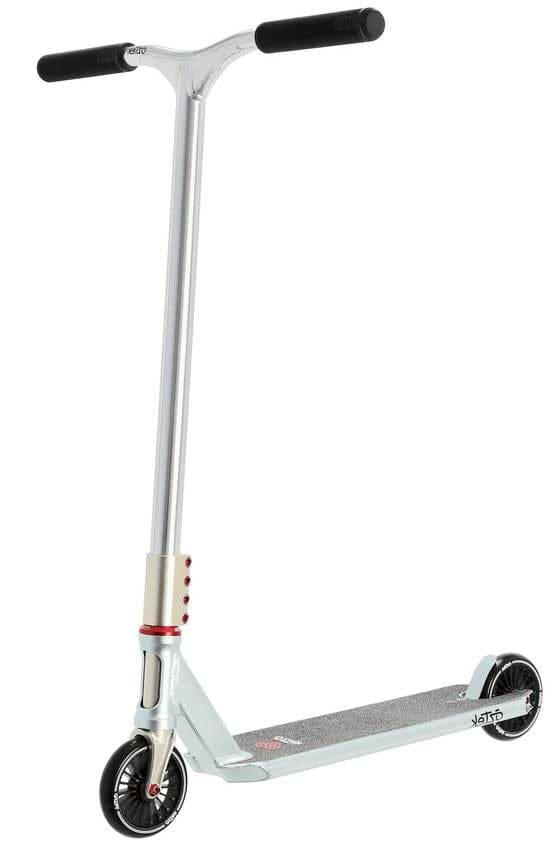 A blue Aztek Corsa Complete Stunt Scooter stands upright on a white background, featuring black handlebars, a flat deck, and two black wheels with red accents near the front wheel. This lightweight stunt scooter is made by Aztek.