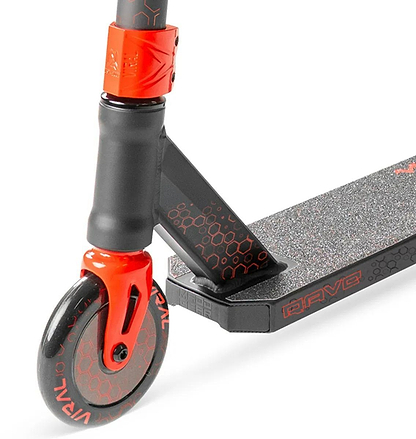 Close-up of the Madd Gear Viral Rave Complete Stunt Scooter - Inferno by MGP, featuring a black and red front wheel, fork, and deck with grip tape and honeycomb details. The deck displays the word "BRAVE" in bold red accents.