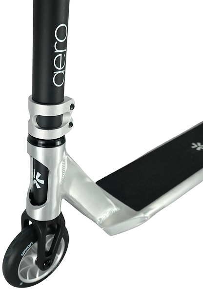 Close-up of the Union Aero Complete Stunt Scooter by Union in Black / Raw, highlighting the front wheel, grip-taped deck, and vertical handlebar tube labeled "aero.