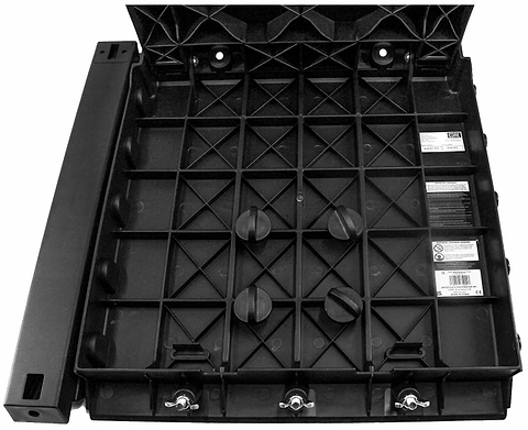 A CORE XL Kicker Ramp Extender by CORE, featuring a black plastic grid-like base with four large knobs, three metal toggle switches, labeled controls, and a side handle, is displayed from above on a white background.