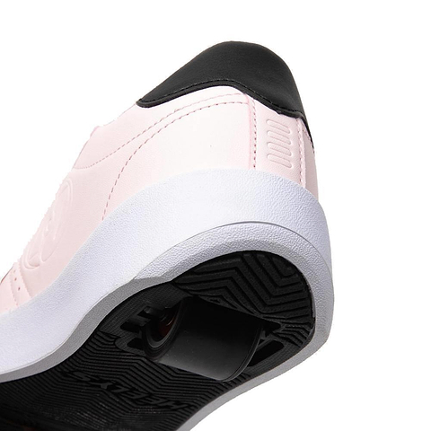 A close-up of Heelys Goleeh Girls Shoes in blush pink and black, featuring a white sole and retractable wheel in the heel, designed for skating. Brand: Heelys.