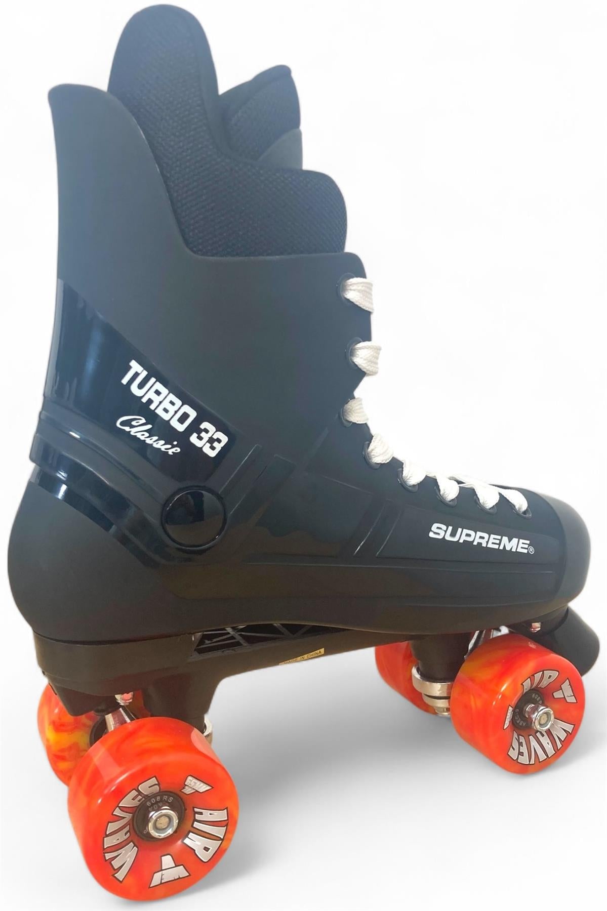 The Supreme Turbo 33 Nylon Quad Roller Skates in black, featuring white laces and striking red swirl wheels, are styled in a classic quad design and photographed against a white background.