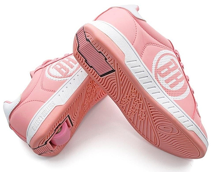 The Breezy Rollers Classic Shoes - Pink / White by Breezy Rollers feature a patented wheel system in the heels, letting you skate or walk with ease. One shoe displays the hidden wheel, while the other shows off the sole’s tread pattern.