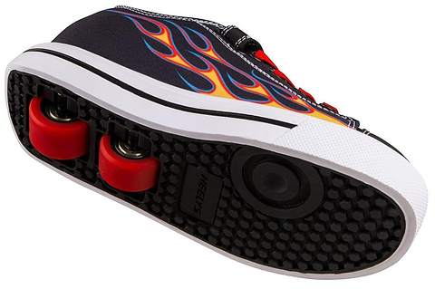 A close-up of the Heelys Snazzy X2 Boys Shoes in black with yellow and red flame design, featuring red wheels and ABEC 3 bearings, highlights their dual-purpose for both walking and rolling.