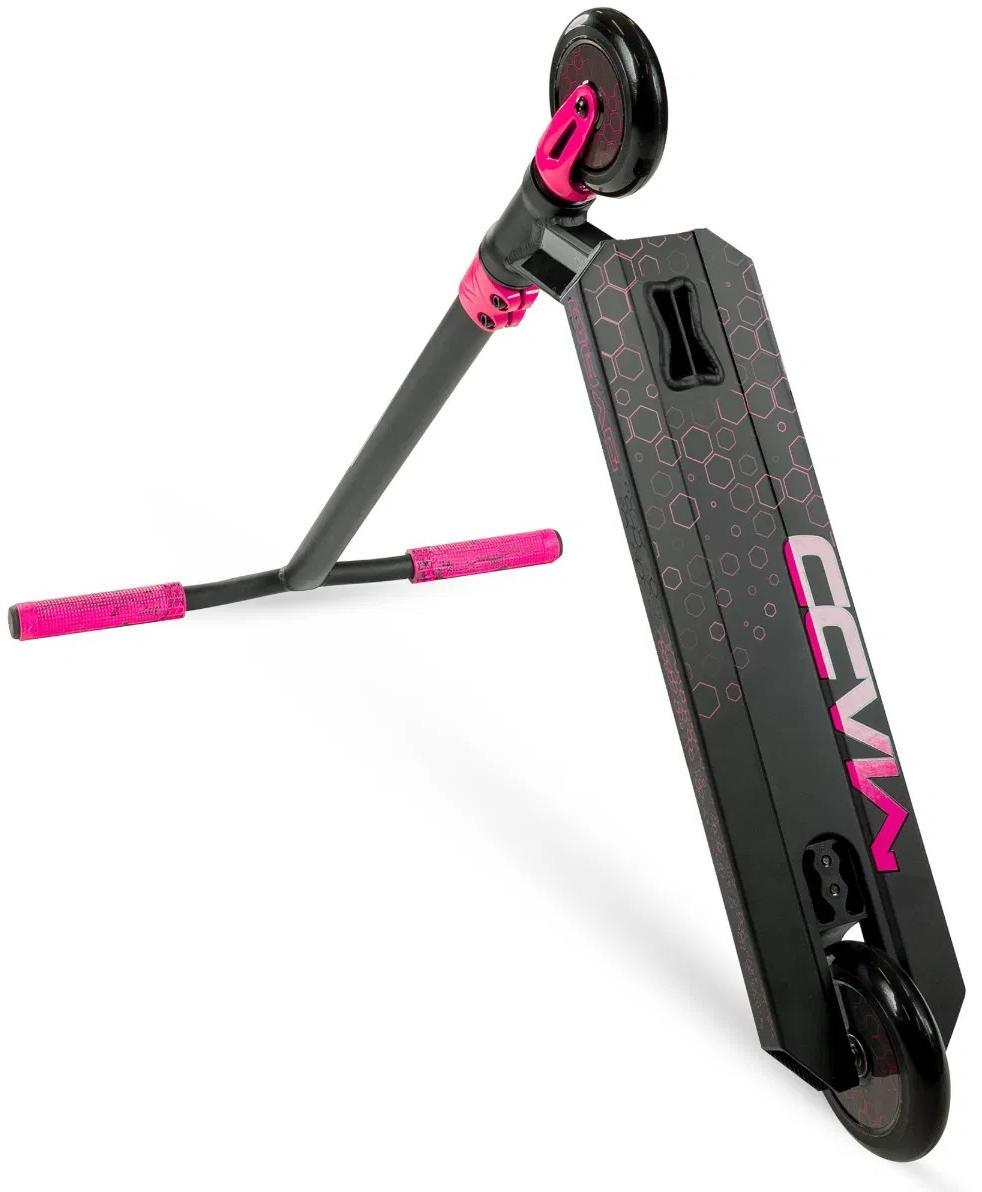 The Madd Gear Viral Rave Complete Stunt Scooter - Melon is shown angled on its side, featuring pink handlebar grips, fork accents, and a geometric pink design on the deck.