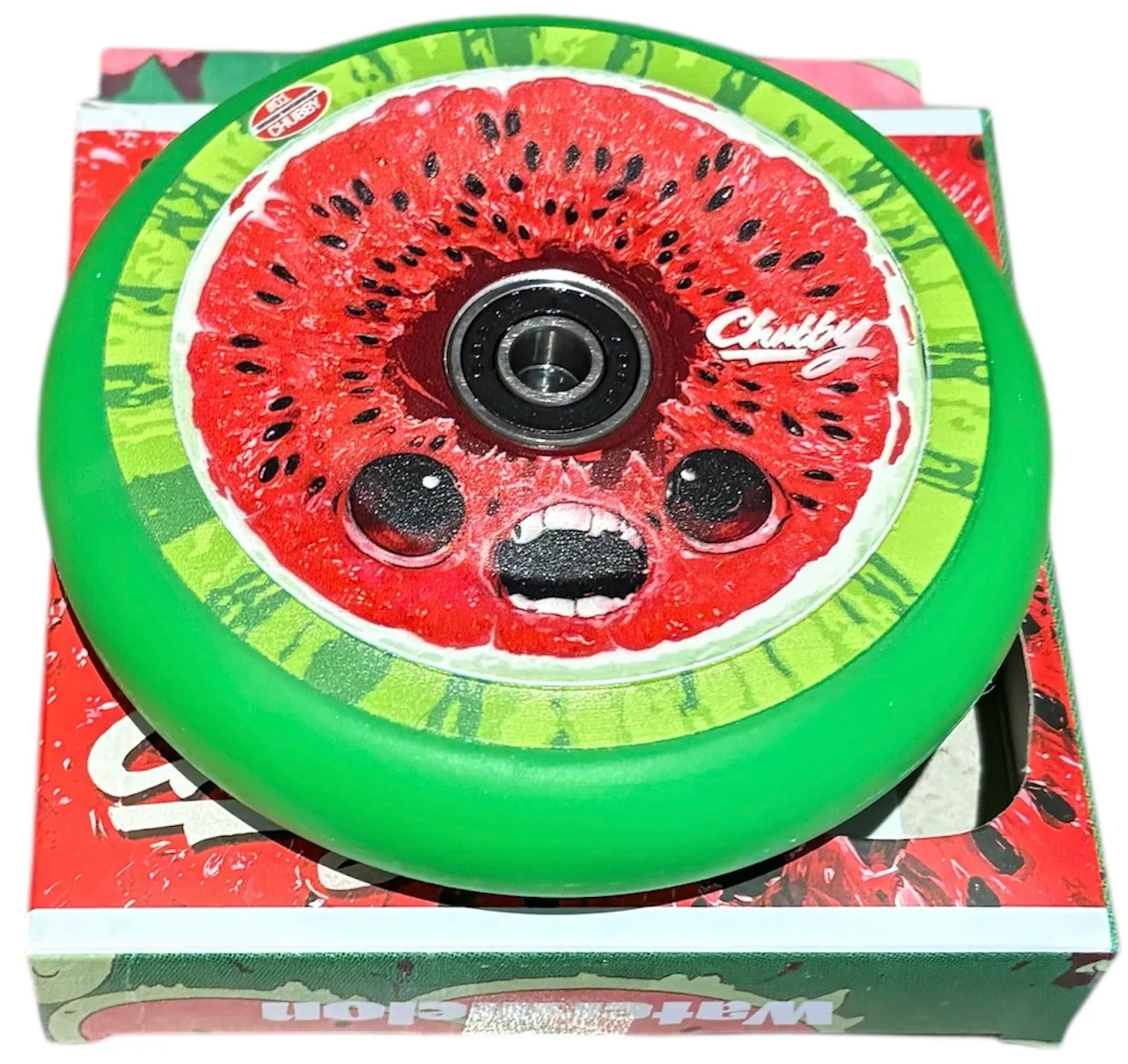 The Chubby Hollowcore 110mm Stunt Scooter Wheel - Watermelon features a cartoon watermelon design, lightweight hollowcore build, bearing included, and comes in green. "Chubby" is printed on the wheel for a bold, playful look.