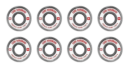 Arranged in two neat rows, the CORE Swiss Ceramic Skateboard Bearings are designed for top-notch skating performance with precise craftsmanship. Each of the eight gray bearings prominently displays "CORE SWISS" and "C3" in red next to a Swiss flag design, all set against a clean white background.
