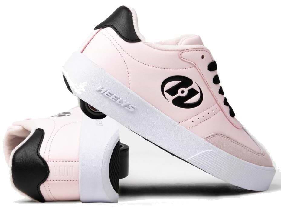 A pair of Heelys Goleeh Girls Shoes in blush pink with black accents and laces, featuring built-in wheels. One shoe stands upright while the other leans against it, showing off the signature Heelys rolling design.
