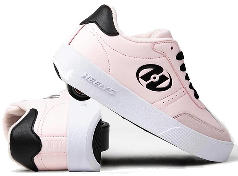 A pair of Heelys Goleeh Girls Shoes in blush pink with black accents and laces, featuring built-in wheels. One shoe stands upright while the other leans against it, showing off the signature Heelys rolling design.