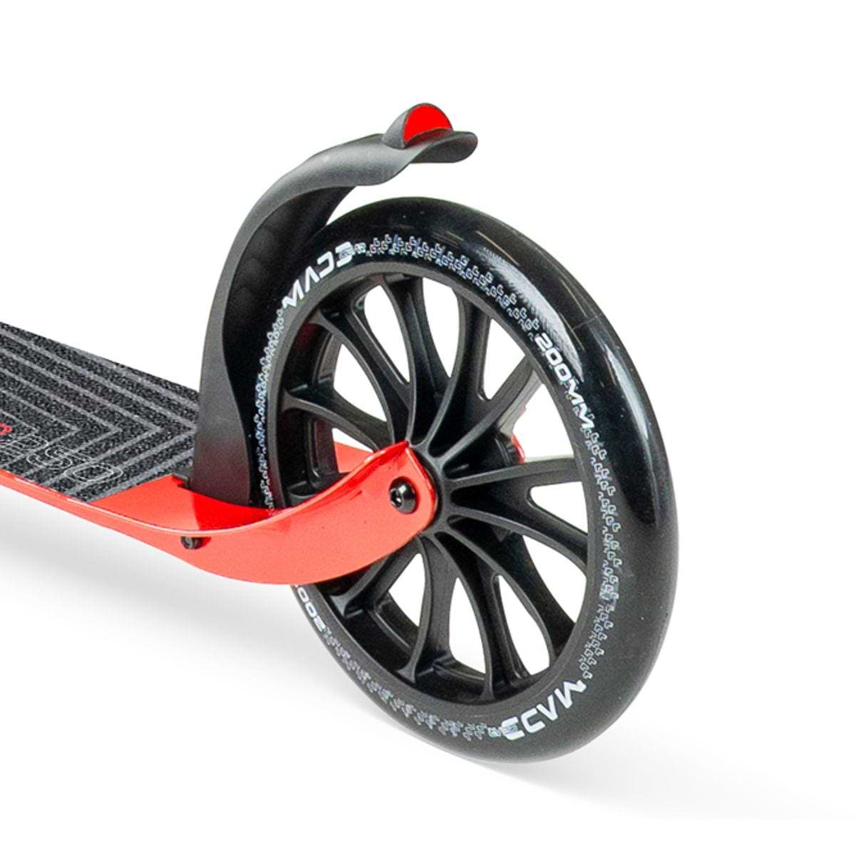 Close-up of the Madd Gear Metro Cruise 250 Foldable Commuter Scooter (Black/Red) by MGP, showing its black tire, black spokes, red frame, black fender, and a textured deck grip for stability on daily commutes.