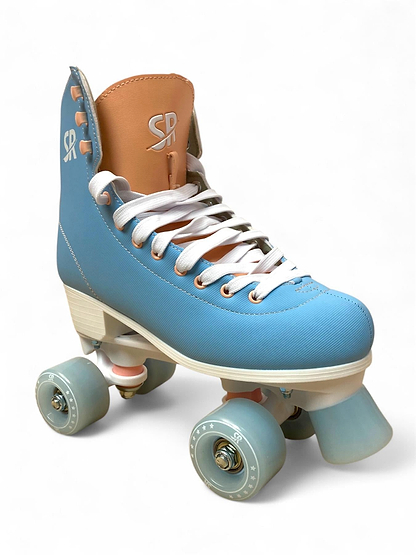 The Supreme Malibu Quad Roller Skates - Light Blue by Supreme feature a high-top light blue and tan design with white laces, four blue wheels, and white accents—ideal for beginners or recreational skating. Photographed on a white background.