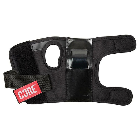 The CORE Classic Skate Protection Wrist Guards in black feature a circular thumb opening, adjustable Velcro straps, and are adorned with a red "CORE Protection" label. These wrist guards combine padded material for support and comfort with a reinforced splint to ensure maximum stability.
