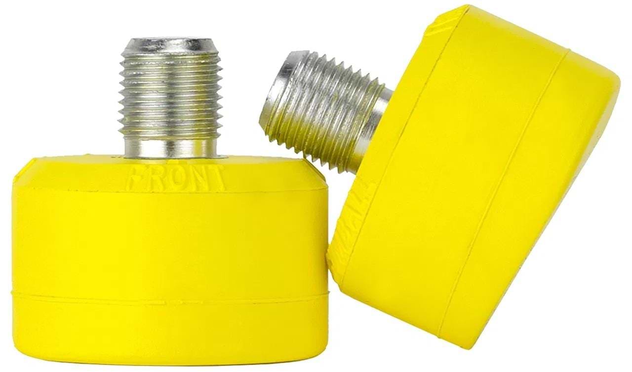 Two Gumball Roller Skate Short 17mm 75A Toe Stops in Lemon Yellow, which resemble gumball toe stops, are shown. One stands upright while the other leans against it, displaying their threaded metallic tops with engraved text—vital tools for improved skating control.