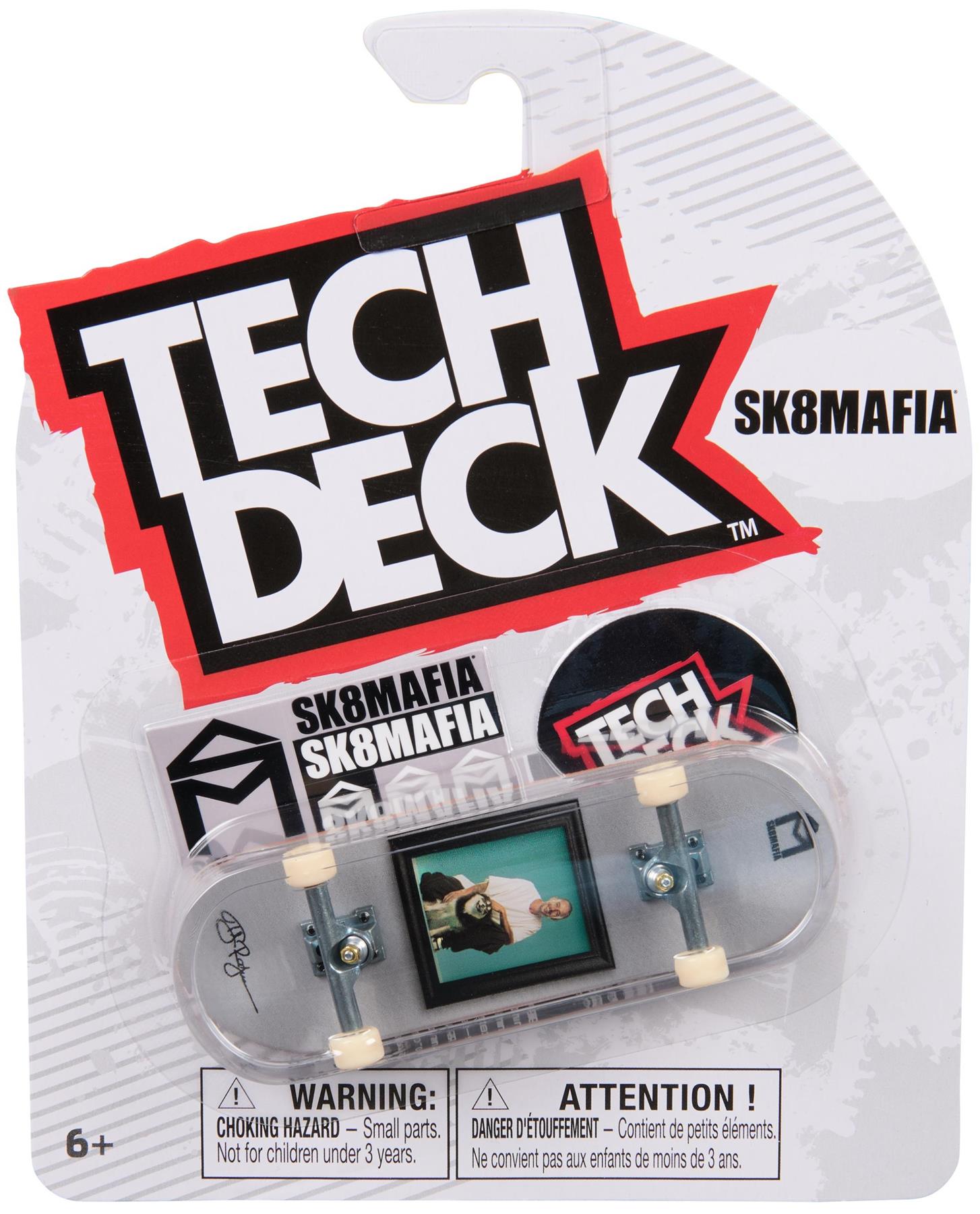 The Tech Deck 96mm M57 Fingerboard - SK8Mafia by Tech Deck features the SK8MAFIA logo and graphic skateboard design. Suitable for ages 6+, it comes in packaging with safety warnings. Perfect for fans of 96mm fingerboards.