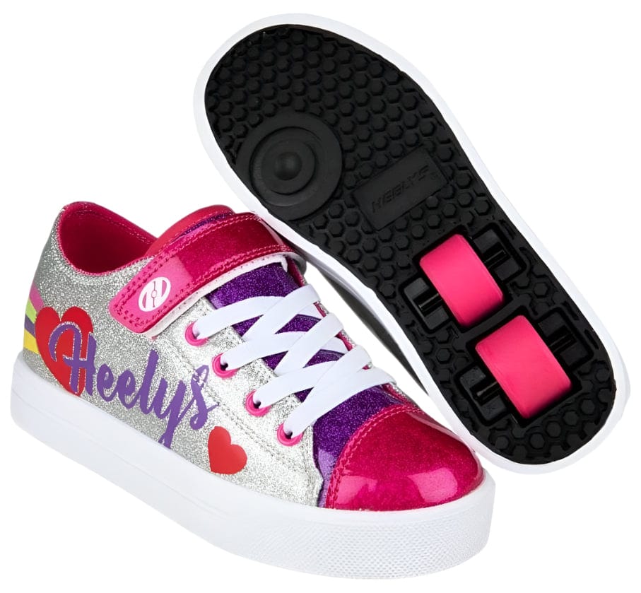 The Heelys Snazzy X2 Girls Shoes by Heelys feature silver, rainbow, and heart designs with pink laces and two wheels per shoe for extra rolling fun.