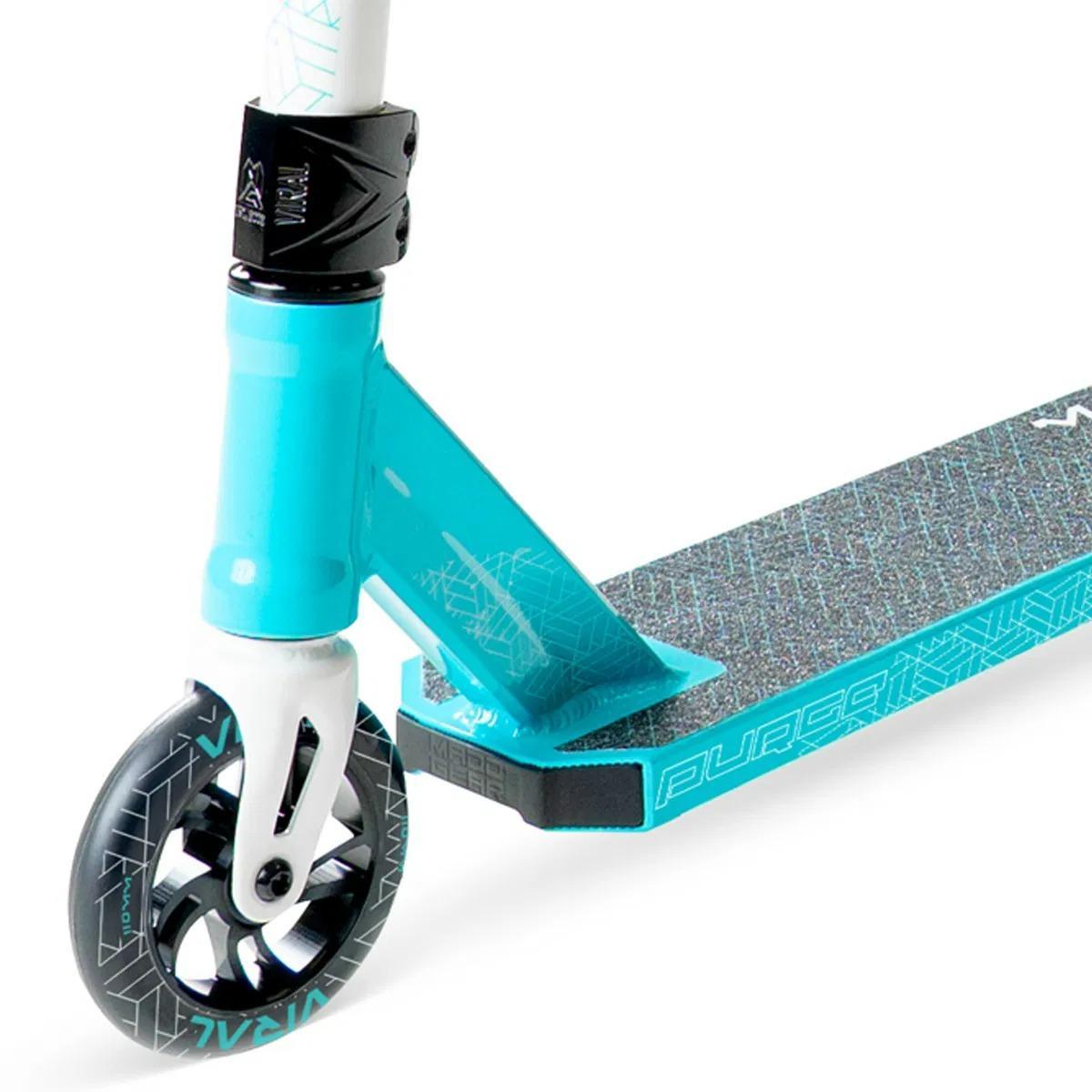 Close-up of the Madd Gear Viral Purge Complete Stunt Scooter - Aqua, showing the front wheel, deck with textured grip and geometric edge patterns, and handlebar base. A kids' stunt scooter by MGP in turquoise and black.