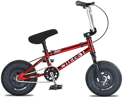 The Wildcat OG 3A Mini BMX Bike – Royal Red Bull is a compact red BMX with thick PRO Street 65PSI tyres, a black seat, sturdy chromoly steel handlebars, one gear, hand brakes, no pedals, and "wildcat" in white on the frame.