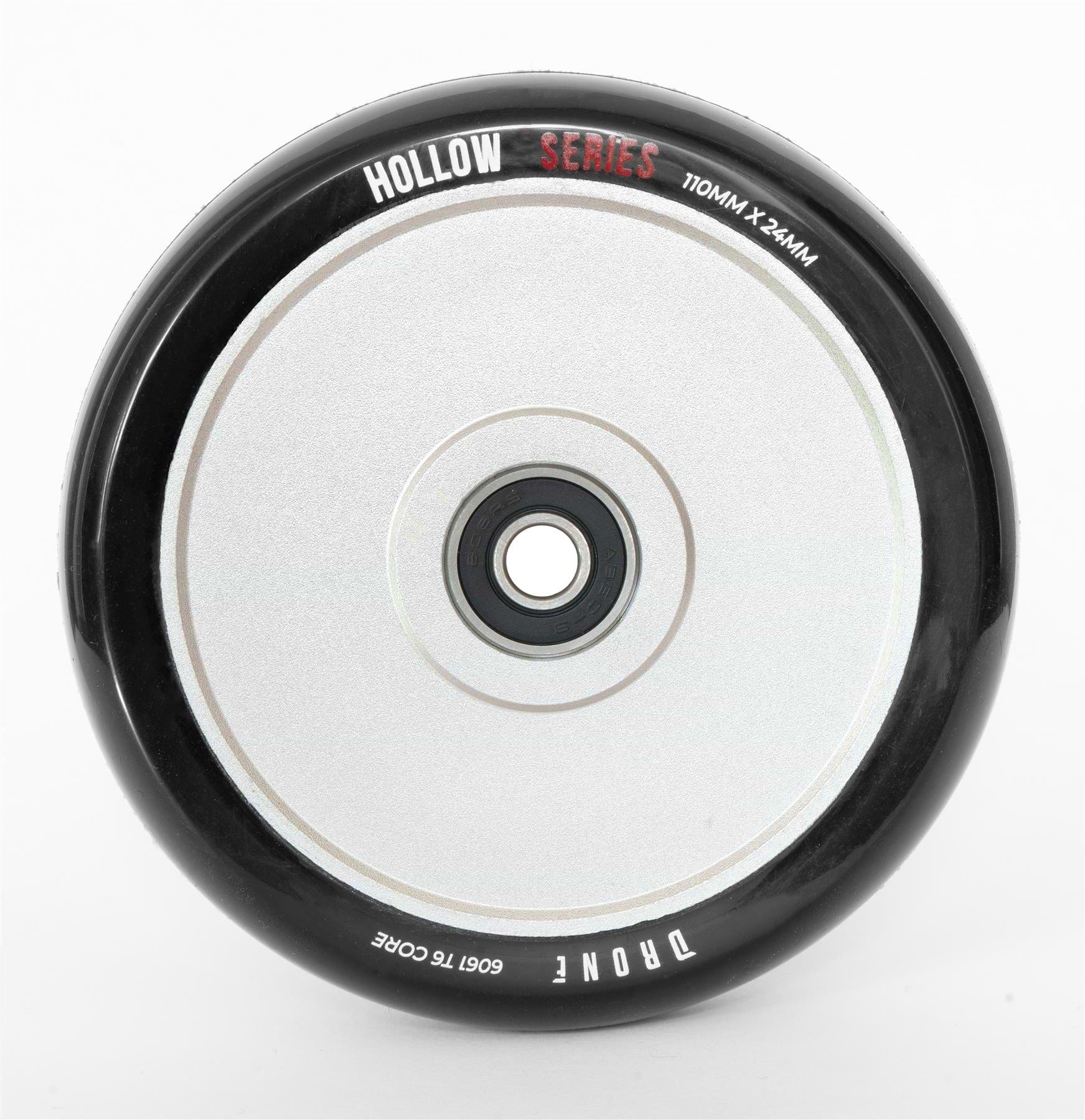 Close-up of the Drone Hollow Series 110mm Stunt Scooter Wheel - Silver, featuring its durable circular design. It has a central hub with a smooth, reflective surface, and its size (110mm x 24mm) is marked on it.